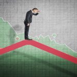 Businessman standing on falling diagram and peering into the future