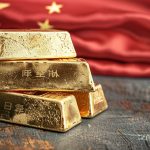 Goldpreis China: Goldbarren vor Flagge – Spread schrumpft